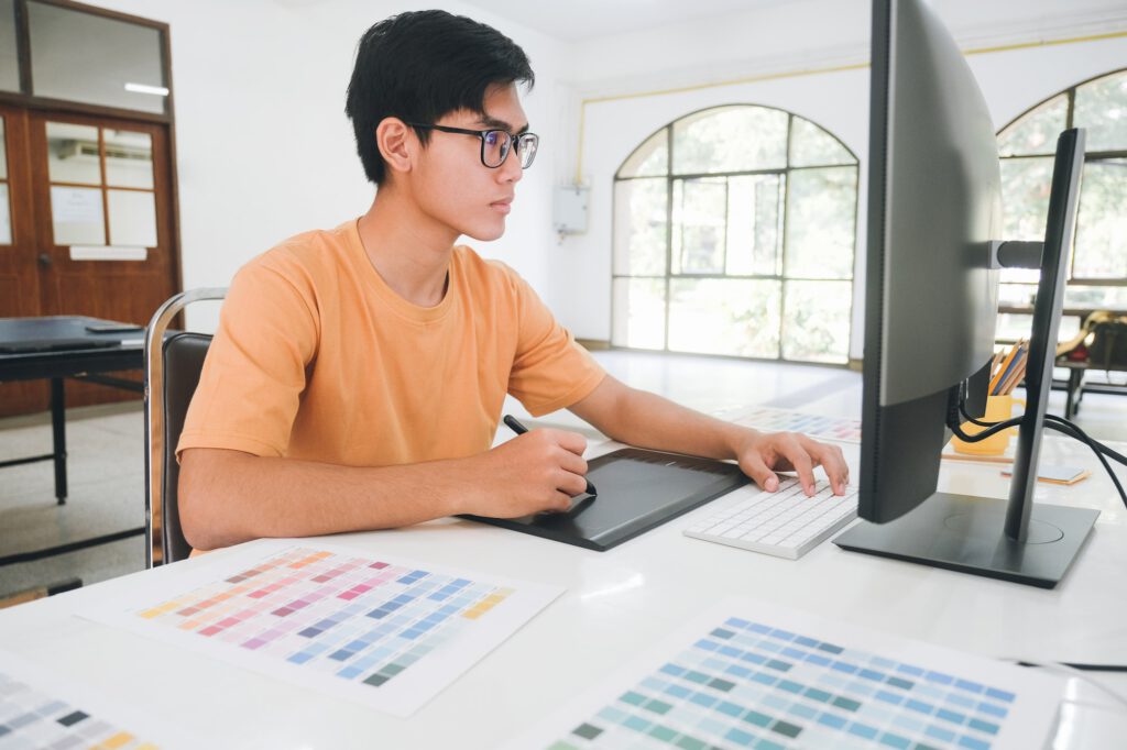 Graphic designer working with color samples for selection.